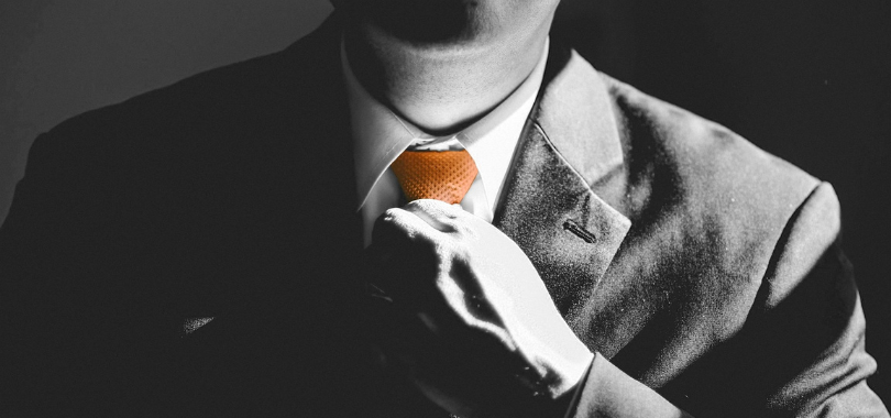 businessman wearing orange tie